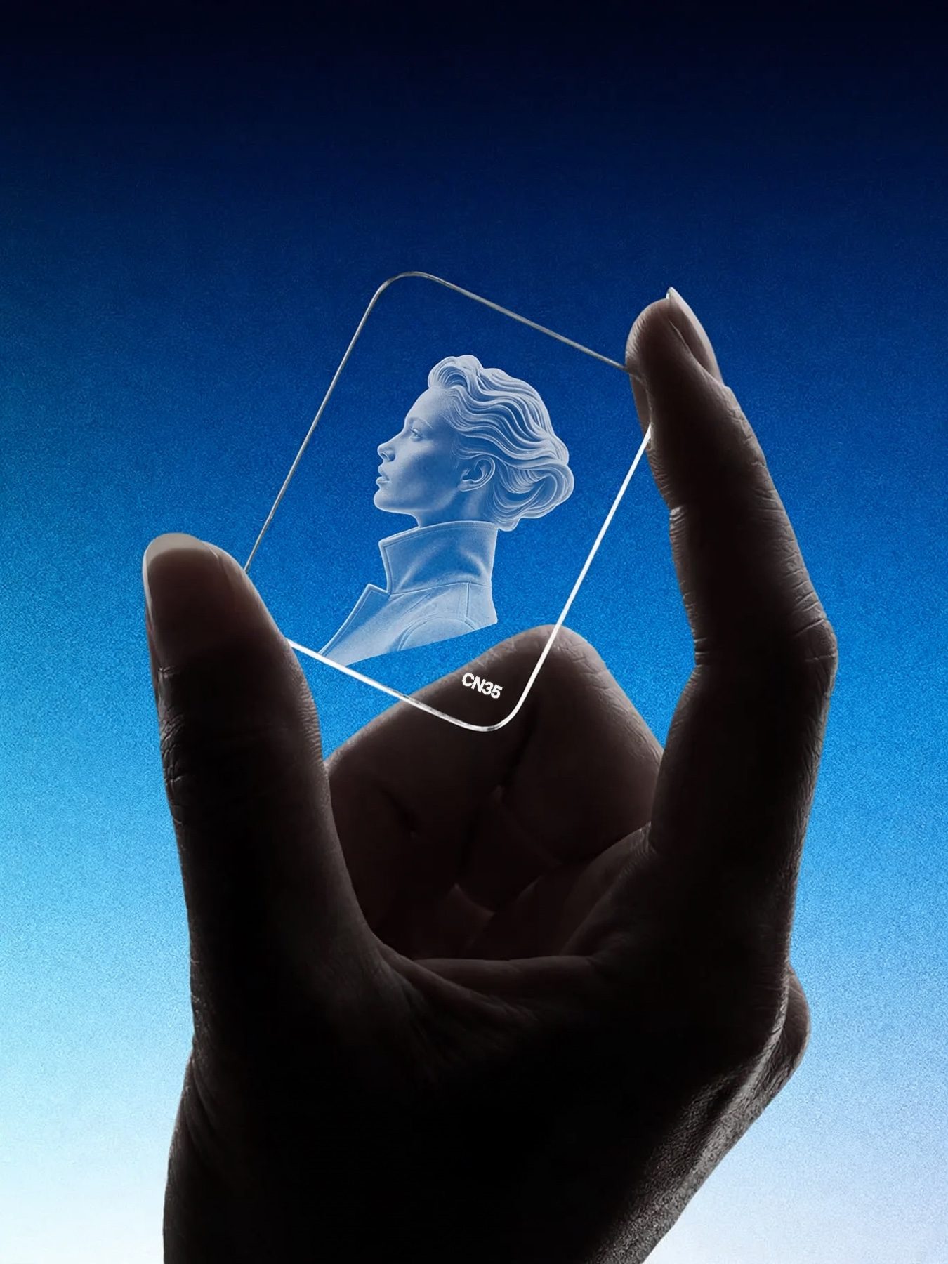 A hand holds a CN35 crystal slide up against a blue gradient